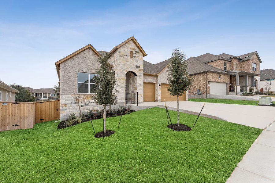 Front exterior of a new home in La Cima, San Marcos, TX, highlighting curb appeal (Image 19).