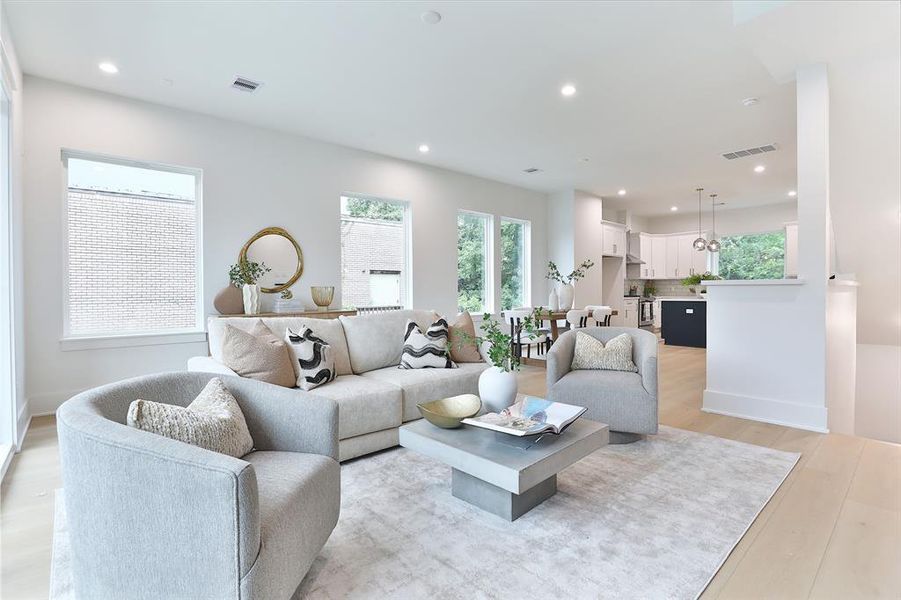 Discover the expansive elegance of this sun-drenched living area, perfectly designed to accommodate a plush sectional and a generous dining set with ease.