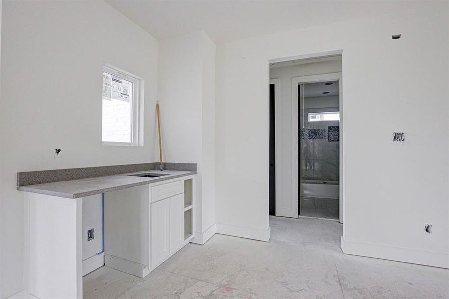 Bathroom featuring tiled shower / bath combo, vanity, and tile patterned floors