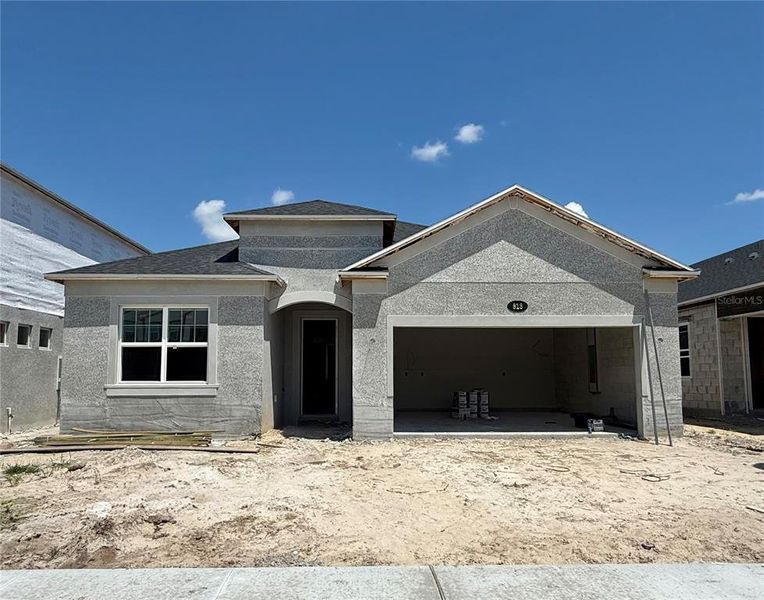 Front exterior of a new home in Estates at Rivercrest, Sanford, FL, highlighting curb appeal (Image 1).