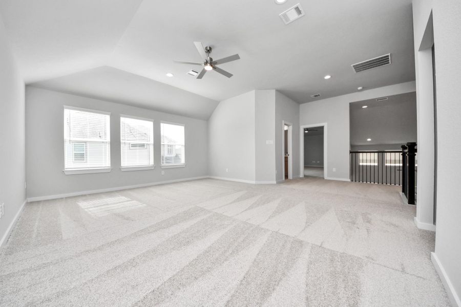 Ascend to relaxation in this fantastic game room! Ideal for both casual gatherings and adult gaming, it boasts plush carpet, lofty ceilings, custom paint, and ample windows for abundant natural light