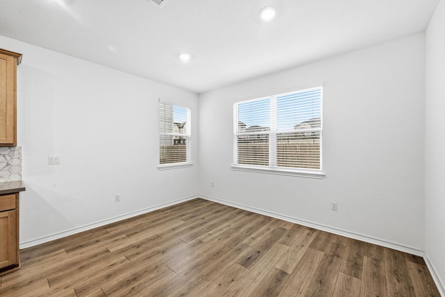 Unfurnished dining area with light wood finished floors and recessed lighting