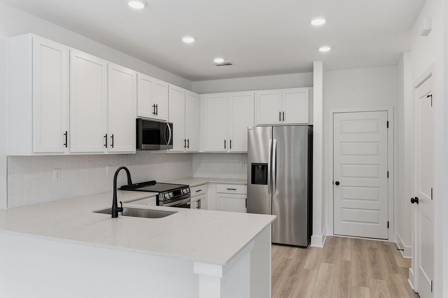 A kitchen with white cabinets. A kitchen with white cabinets.