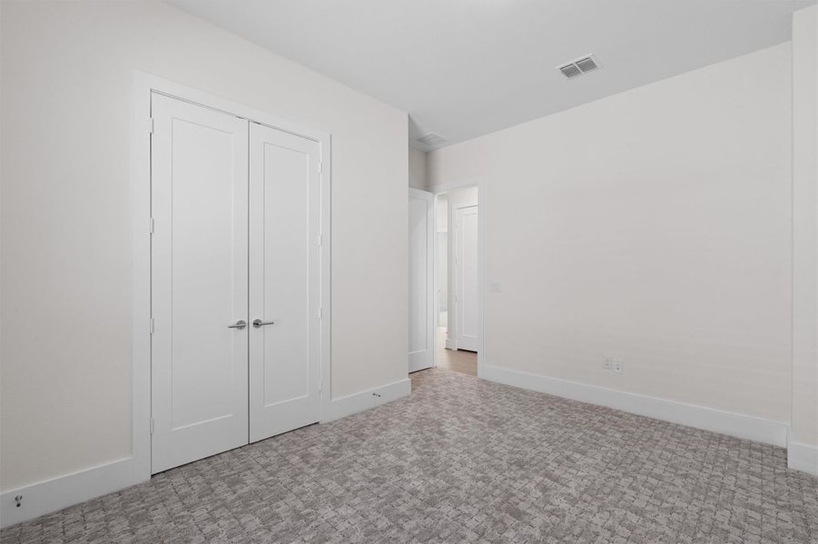 Unfurnished bedroom with baseboards and a closet Unfurnished bedroom with baseboards and a closet