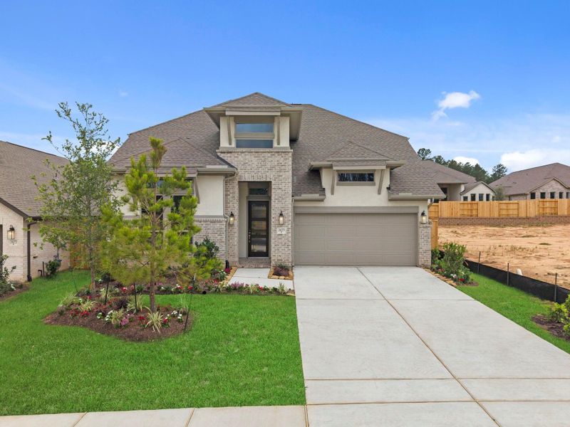 Front exterior of a new home in Wildtree, Magnolia, TX, highlighting curb appeal (Image 18).