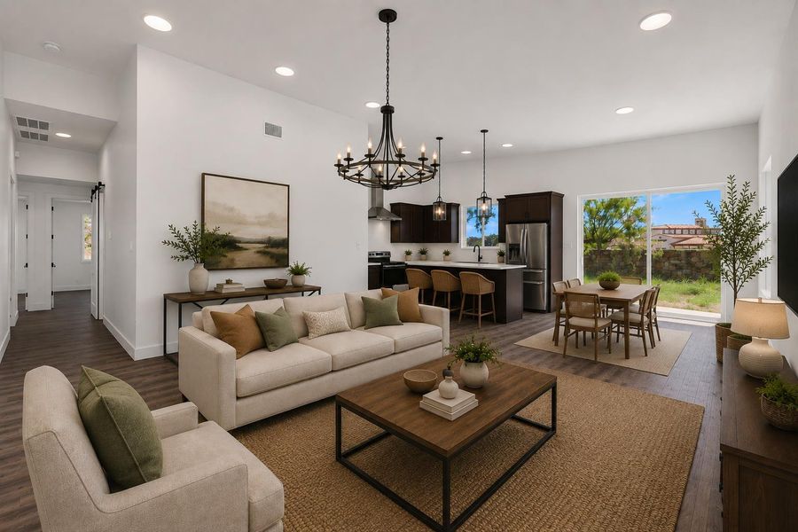 Virtually staged; high ceilings and an open-concept layout integrate the living, dining, and kitchen areas seamlessly.