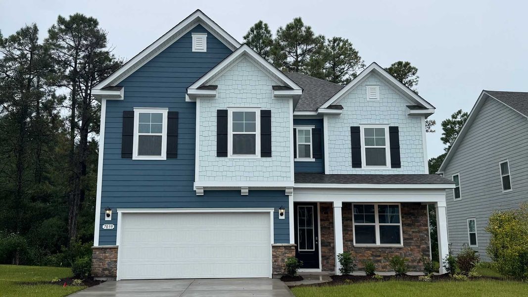 Front exterior of a new home in Waterbridge, Myrtle Beach, SC, highlighting curb appeal (Image 1).