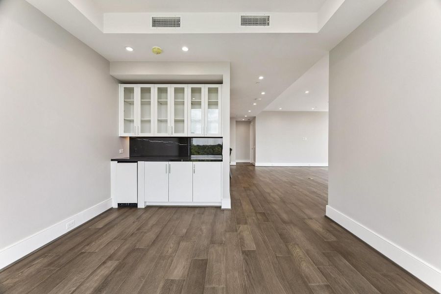 Photo of the actual formal dining room featuring a custom built-in bar, under-counter ice-maker and glass-front upper cabinets for displaying your wine glasses.