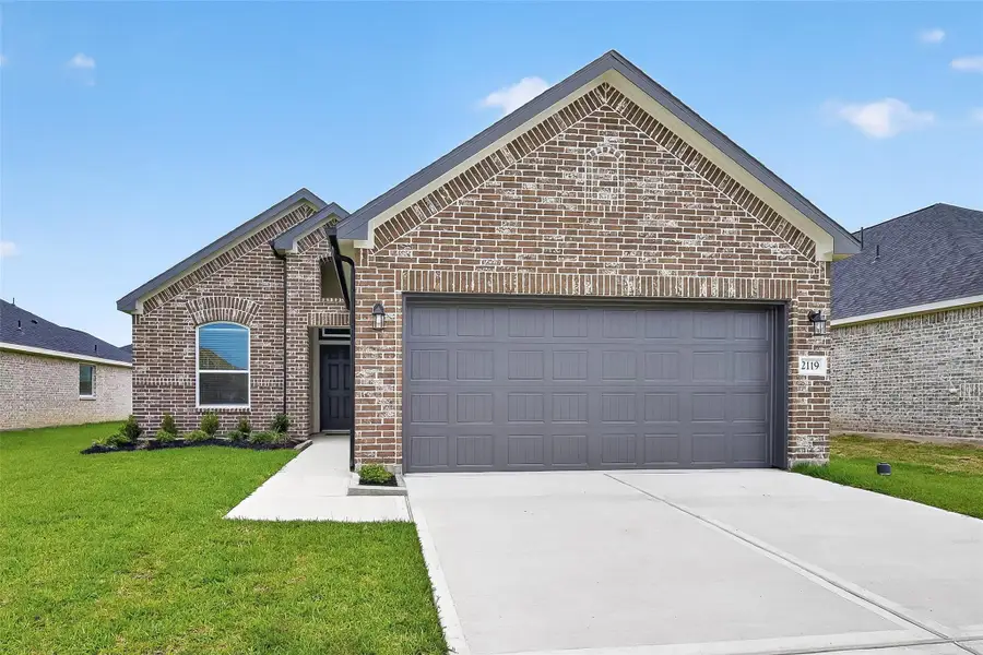 Front exterior of a new home in Grand Magnolia, Magnolia, TX, highlighting curb appeal (Image 24). Front exterior of a new home in Grand Magnolia, Magnolia, TX, highlighting curb appeal (Image 24).