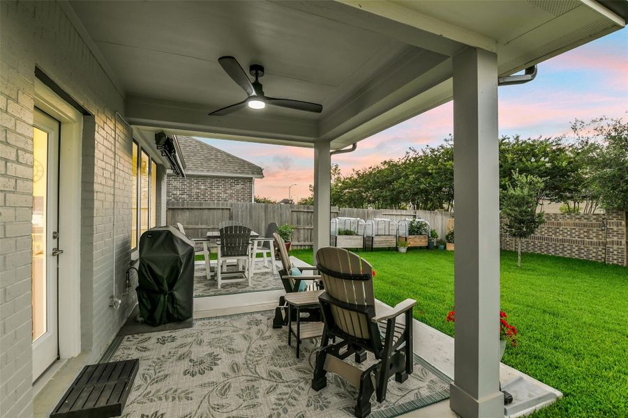 The covered back patio provides beautiful shaded space to enjoy the lush backyard!
