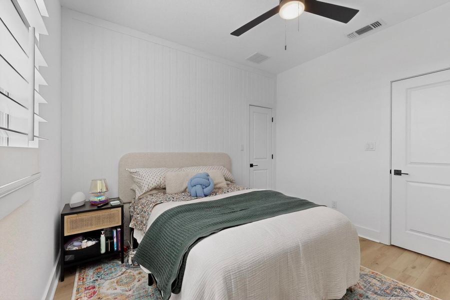 Bedroom  #2 on upper level with light wood-style flooring and ceiling fan