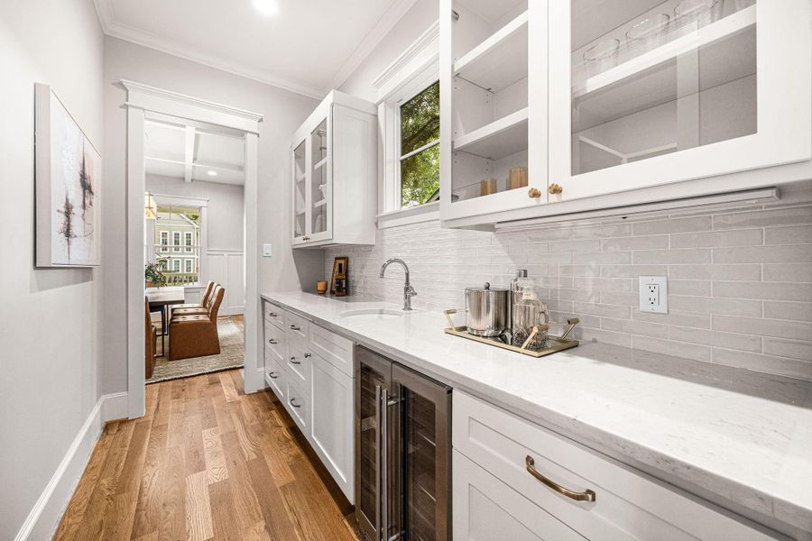 Gorgeous and functional butler's pantry with beverage fridge, sink and upgraded display glass. Gorgeous and functional butler's pantry with beverage fridge, sink and upgraded display glass.