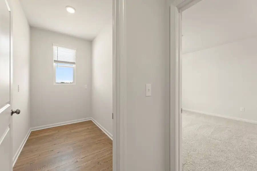 A room with a wood floor and white walls. A room with a wood floor and white walls.