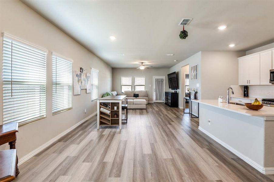 Living area featuring recessed lighting, light wood-style flooring, and ceiling fan