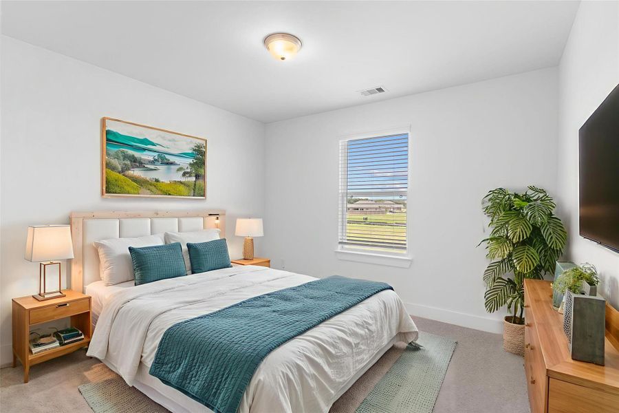 Comfortable secondary bedroom with plush carpet, bright window views, and plenty of space for furnishings. *Virtually Staged* Comfortable secondary bedroom with plush carpet, bright window views, and plenty of space for furnishings. *Virtually Staged*