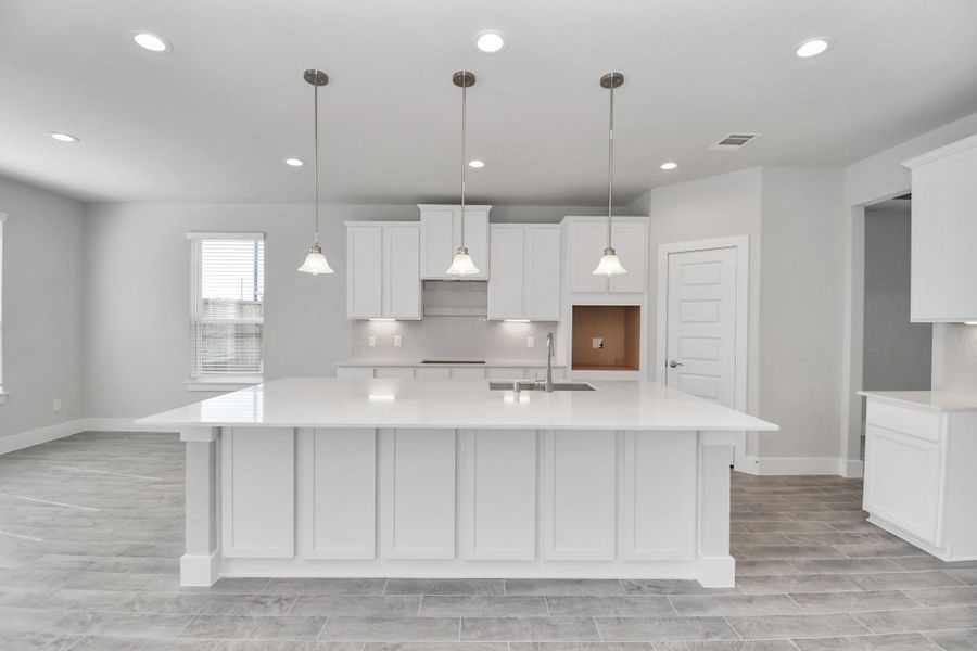 This kitchen is by far any chef’s dream! This spacious kitchen features high ceilings, light stained wood cabinets, granite countertop, SS appliances, modern tile backsplash, recessed lighting, extended counter space, granite kitchen island with double sink, and space for breakfast bar, and a walk-in pantry all overlooking your huge family room. Sample photo of completed home with similar floor plan. Actual colors and selections may vary.