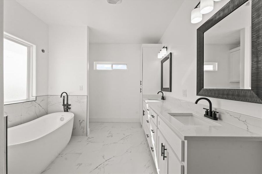 Bathroom with vanity and a tub