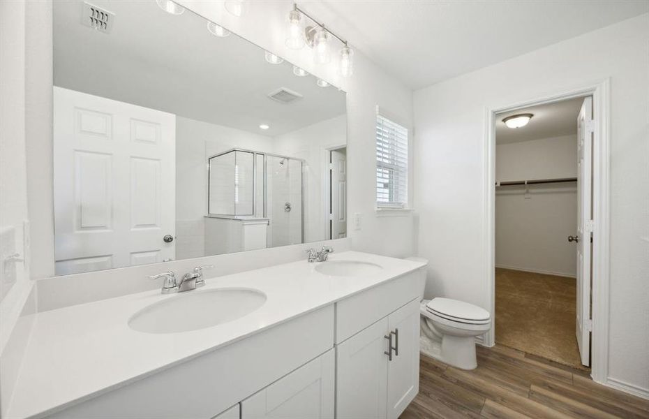 Elegant owner's bathroom with dual vanity *real home pictured