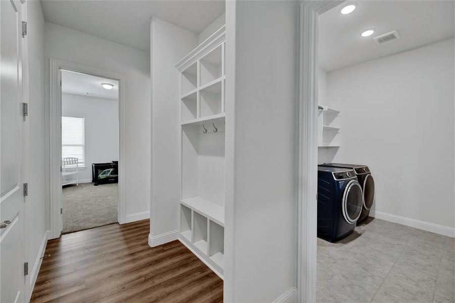 Mudroom featuring washer and dryer and light wood-type flooring