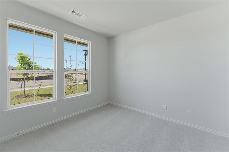 Unfurnished room featuring light colored carpet and baseboards