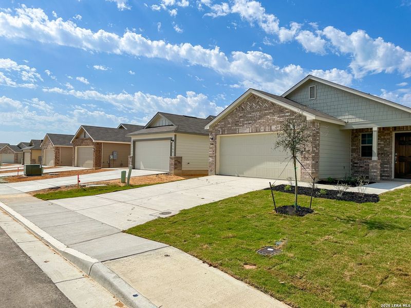 Front exterior of a new home in Park Place, New Braunfels, TX, highlighting curb appeal (Image 2). Front exterior of a new home in Park Place, New Braunfels, TX, highlighting curb appeal (Image 2).