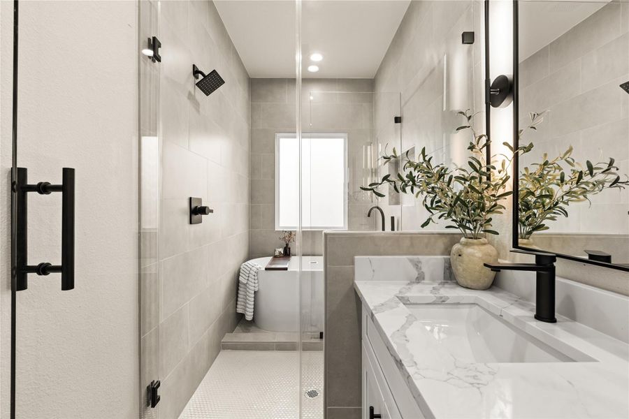 Primary bath featuring a frameless glass shower and a soaking tub — your own personal spa Primary bath featuring a frameless glass shower and a soaking tub — your own personal spa