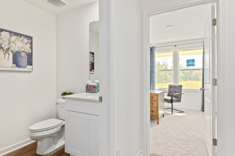 A bathroom with a chair and a sink.