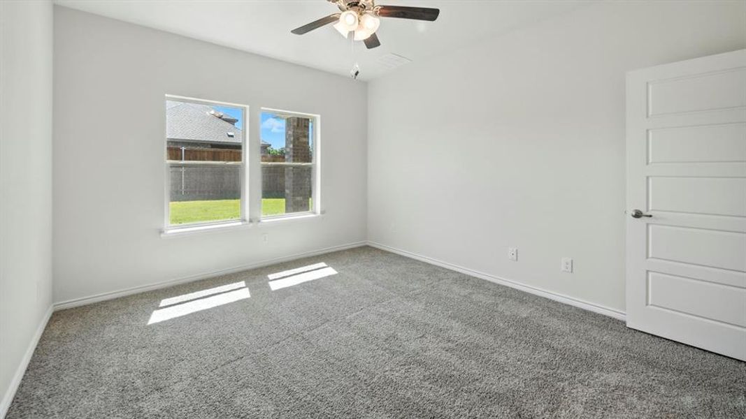 Spare room featuring carpet floors and ceiling fan Spare room featuring carpet floors and ceiling fan