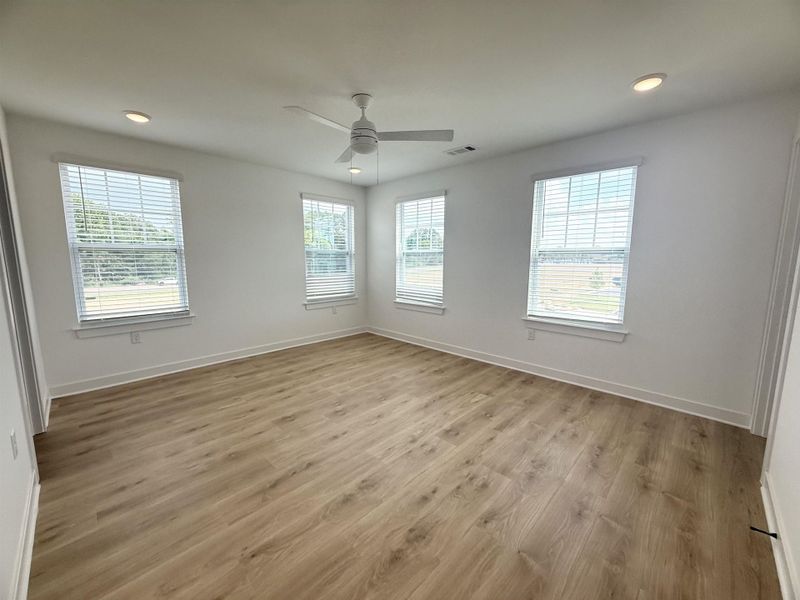 Empty room with a ceiling fan, light wood-style floors, and recessed lighting