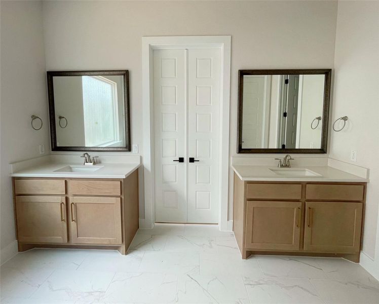 Two individual vanity sinks create functional symmetry in this well-appointed bathroom. Two individual vanity sinks create functional symmetry in this well-appointed bathroom.