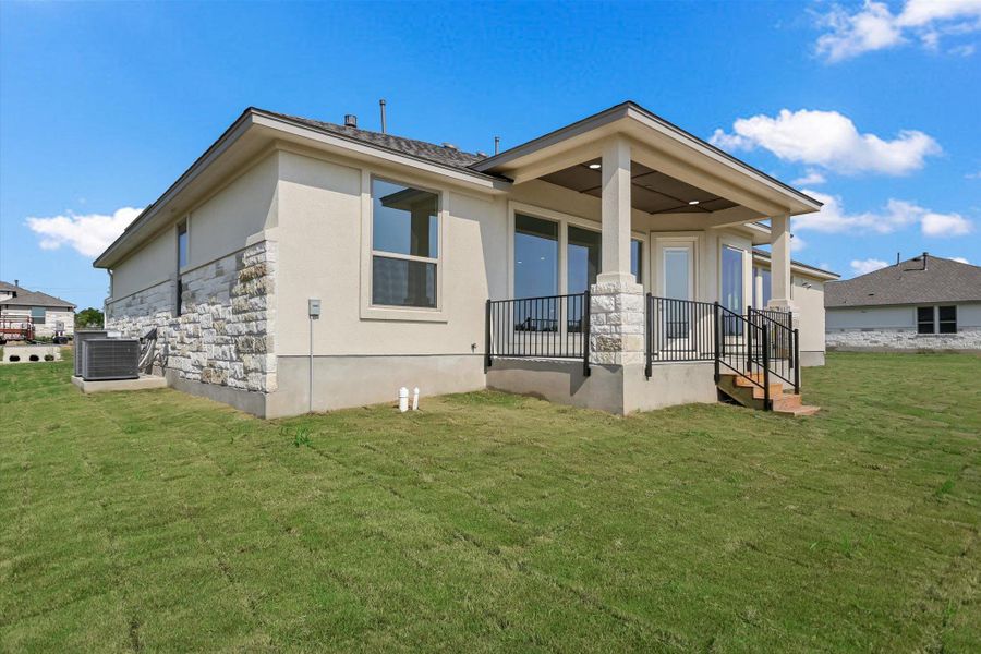 Front exterior of a new home in Scofield Farms Estates, Georgetown, TX, highlighting curb appeal (Image 1).