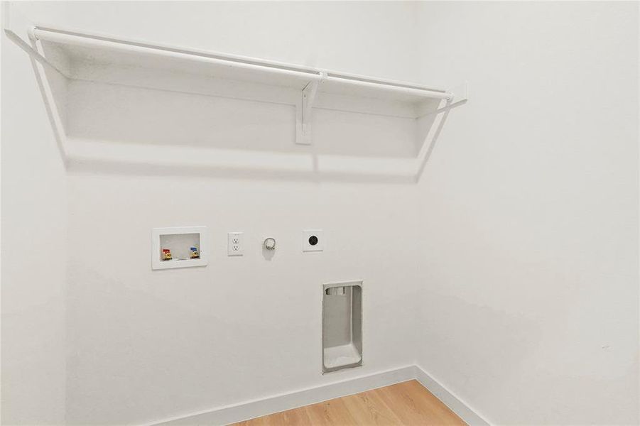 Washroom featuring light wood finished floors, gas dryer hookup, hookup for a washing machine, and electric dryer hookup
