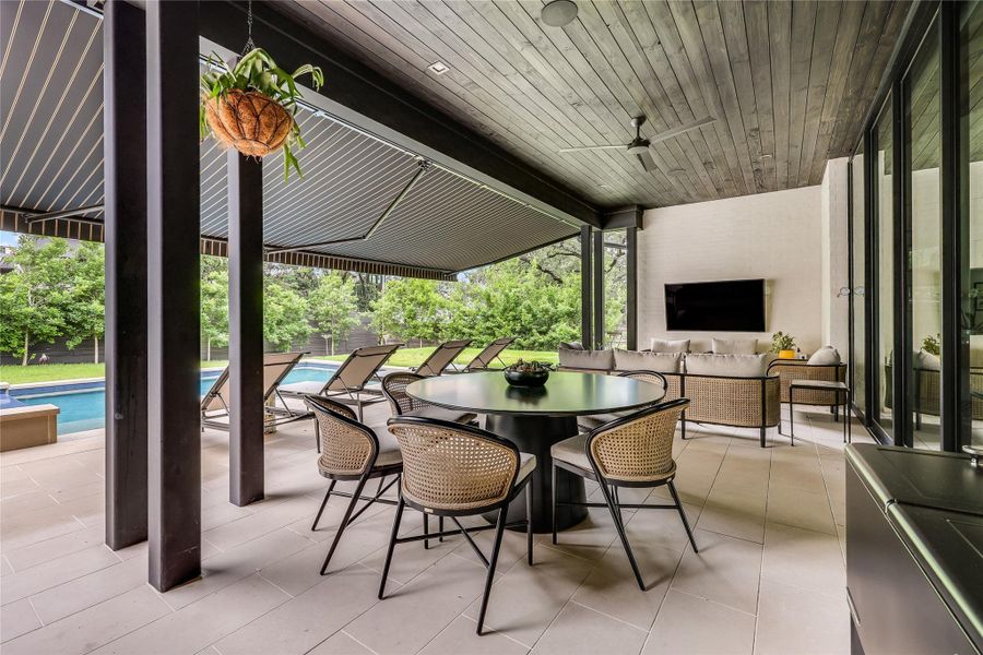 An inviting outdoor living space with pool views provides the perfect setting for relaxation or entertaining.