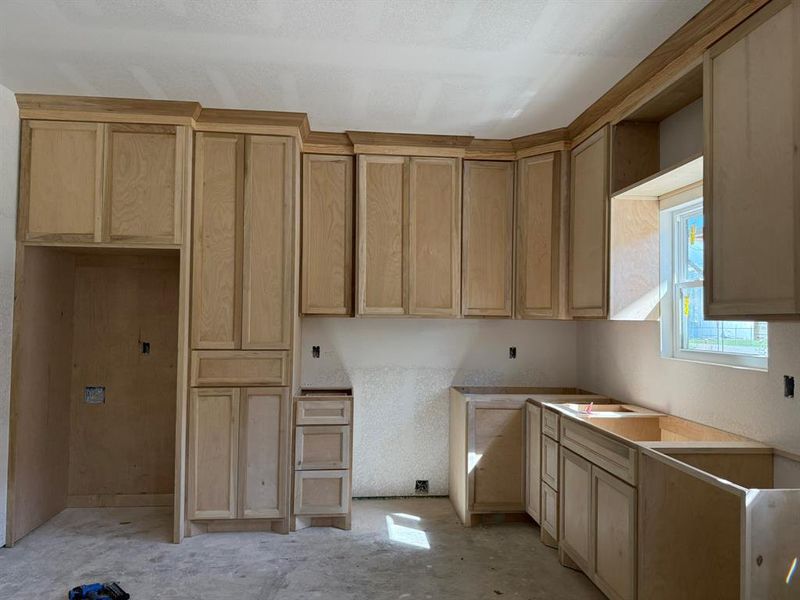 Kitchen featuring light brown cabinetry