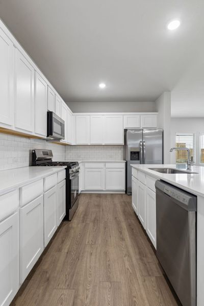 Kitchen in the Oscar home plan by Trophy Signature Homes – REPRESENTATIVE PHOTO