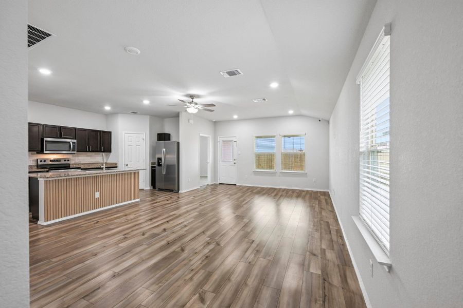 Open concept living area featuring wood-finish flooring, recessed lighting, and a ceiling fan