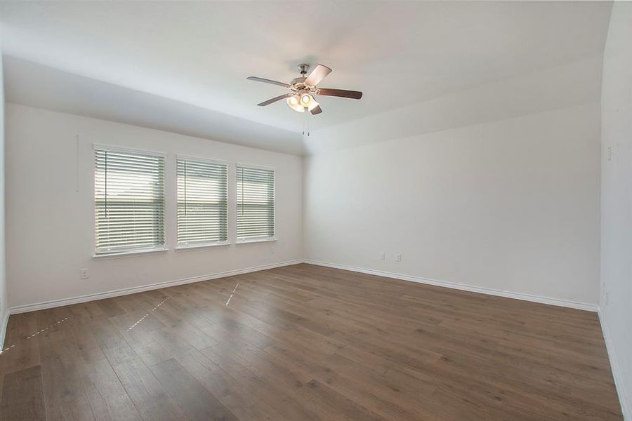 Spare room featuring ceiling fan and dark hardwood / wood-style floors