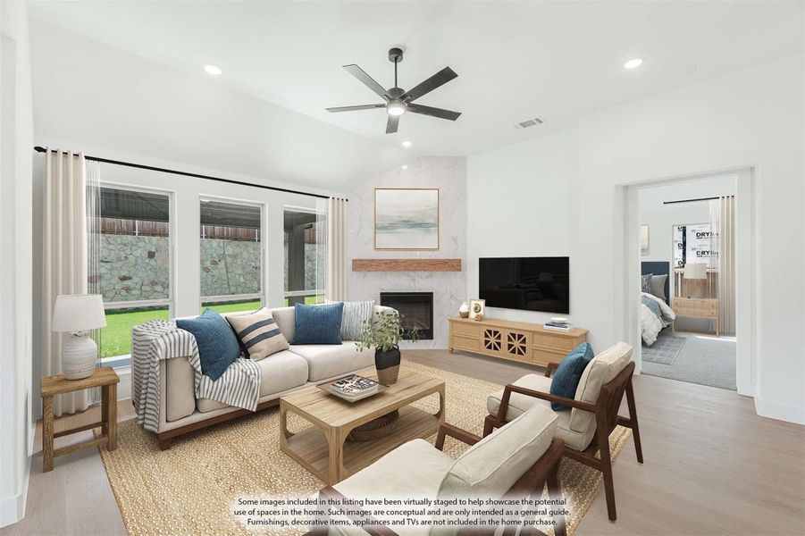 Living room with marble fireplace, ceiling fan, hardwood floors, and large windows overlooking backyard Living room with marble fireplace, ceiling fan, hardwood floors, and large windows overlooking backyard