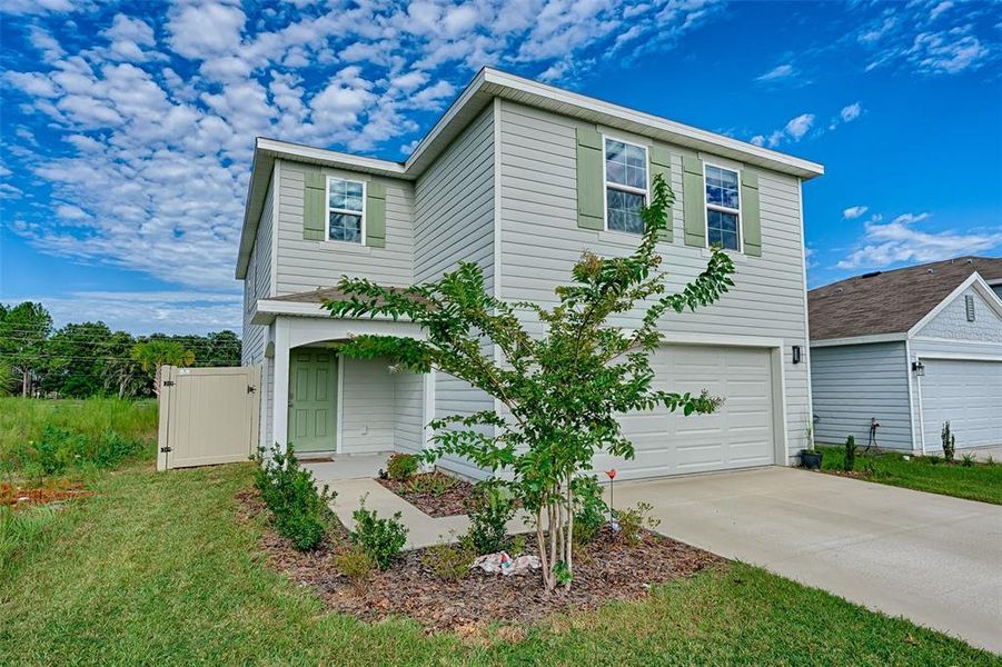 Front exterior of a new home in Avalon Woods, Newberry, FL, highlighting curb appeal (Image 23). Front exterior of a new home in Avalon Woods, Newberry, FL, highlighting curb appeal (Image 23).