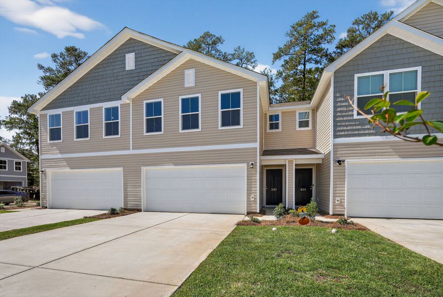 A house with garages and grass.