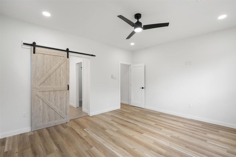 Unfurnished bedroom with light wood-type flooring, ceiling fan, and recessed lighting Unfurnished bedroom with light wood-type flooring, ceiling fan, and recessed lighting