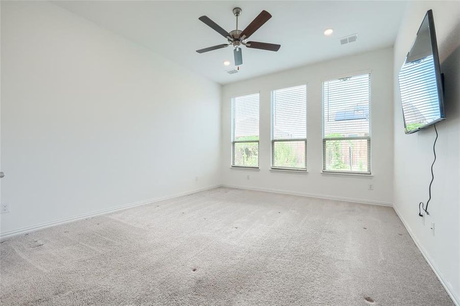 Carpeted spare room featuring a ceiling fan and recessed lighting Carpeted spare room featuring a ceiling fan and recessed lighting