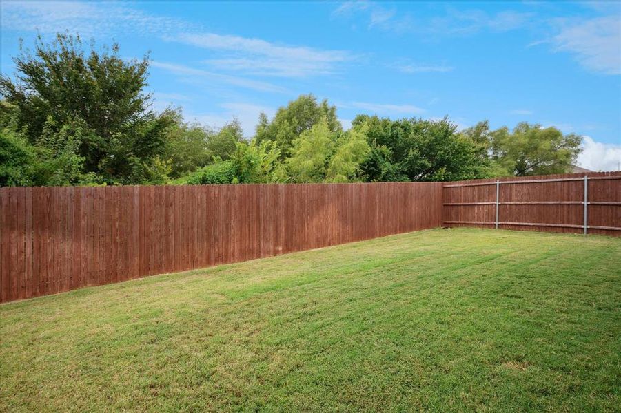 View of large, private fenced backyard. View of large, private fenced backyard.