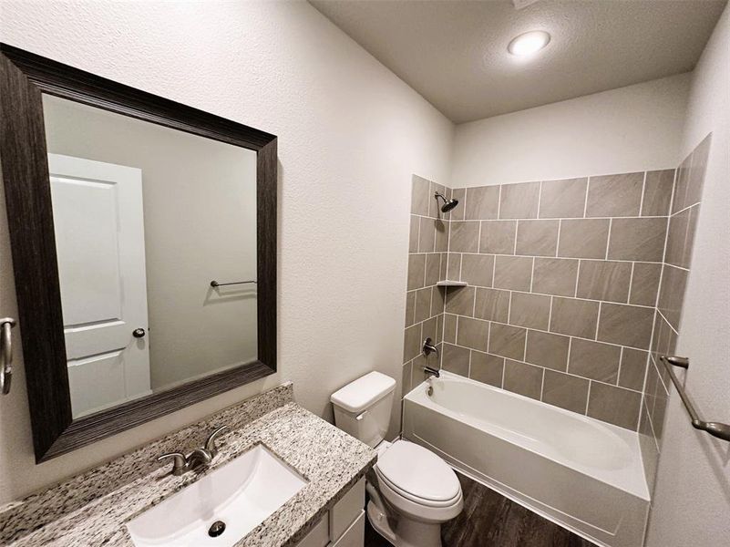 Bath 2 includes granite counters, framed mirror & ceramic tile tub/shower walls