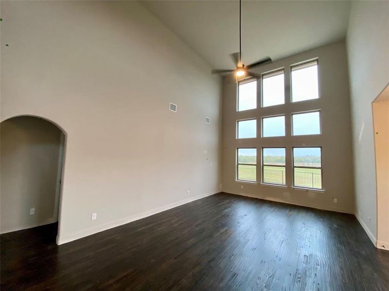 Impressive cathedral ceiling and wall of windows looking out onto your yard & serene nature area!