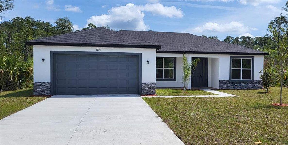 Front exterior of a new home in , Bunnell, FL, highlighting curb appeal (Image 1). Front exterior of a new home in , Bunnell, FL, highlighting curb appeal (Image 1).