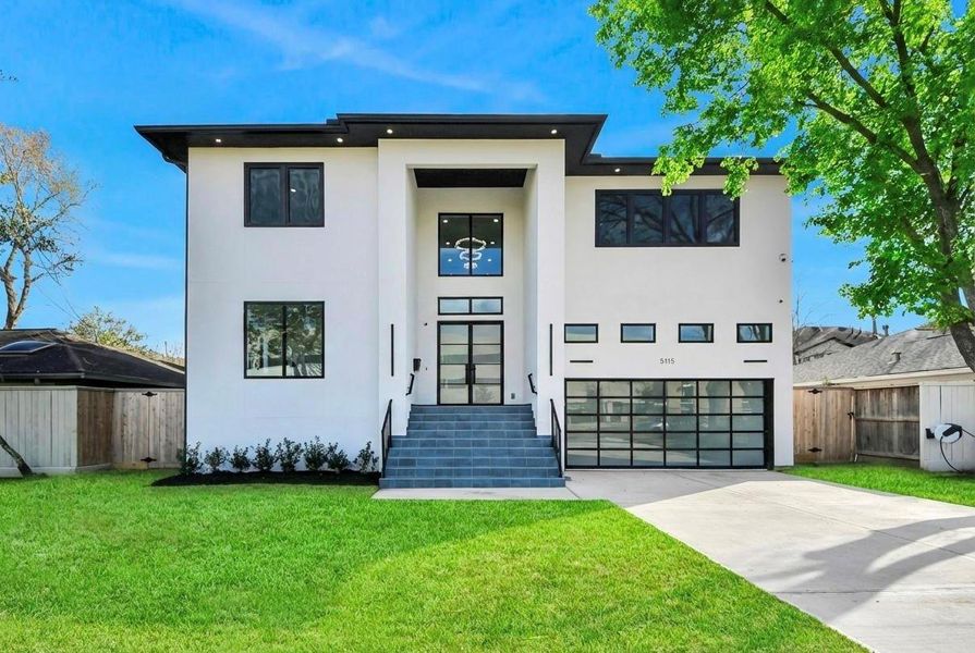 Beautifully framed by mature trees and manicured landscaping, this stunning modern residence blends bold architecture with inviting curb appeal in a serene neighborhood setting.