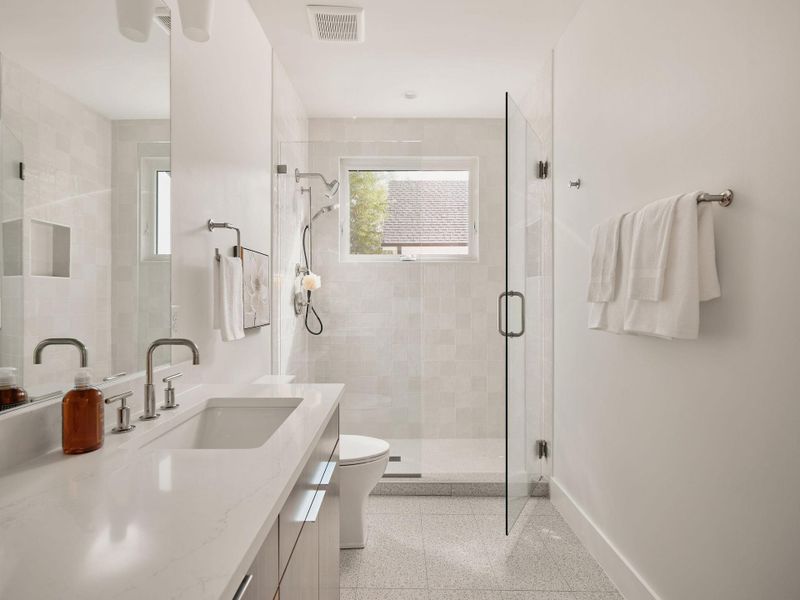 Bathroom with vanity and a shower stall Bathroom with vanity and a shower stall