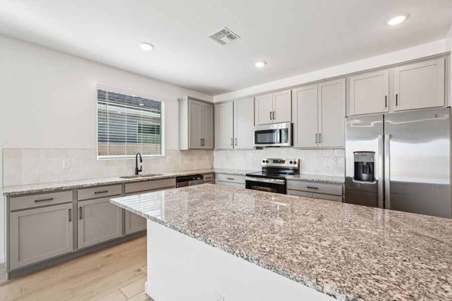 Kitchen featuring the Artisan Collection. Finishes may vary by community.