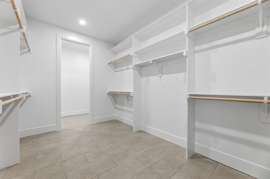 Look at this enormous Walk-in closet with lots of hanging and storage space Look at this enormous Walk-in closet with lots of hanging and storage space